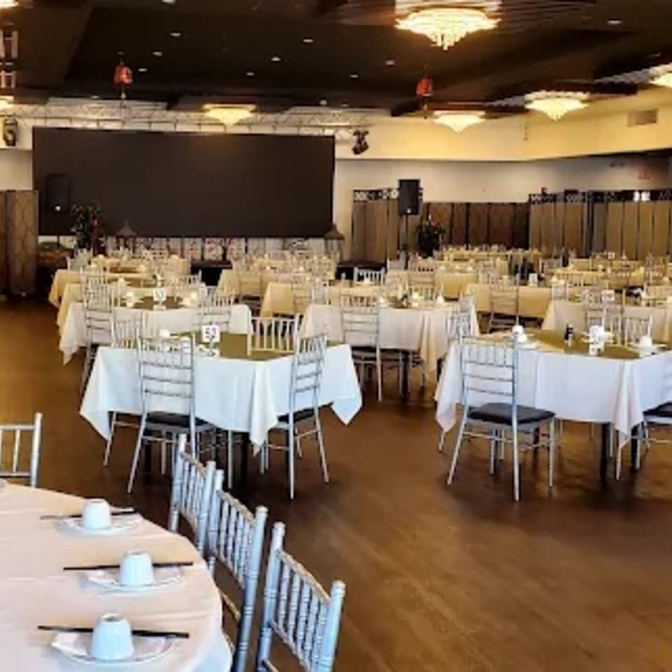 A large, elegant dining hall at Diamond Palace with many tables set for a banquet.